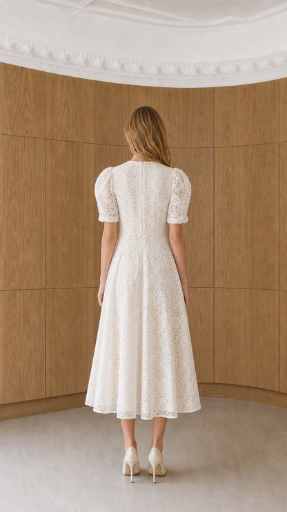 Back view of model wearing white floral lace puff sleeve midi dress