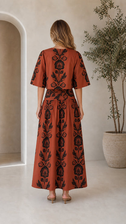 Back view of rust floral print matching top and tiered maxi skirt set