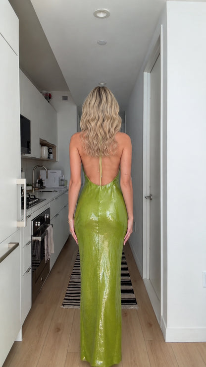 Back view of model showing open back design of lime green sequin maxi dress