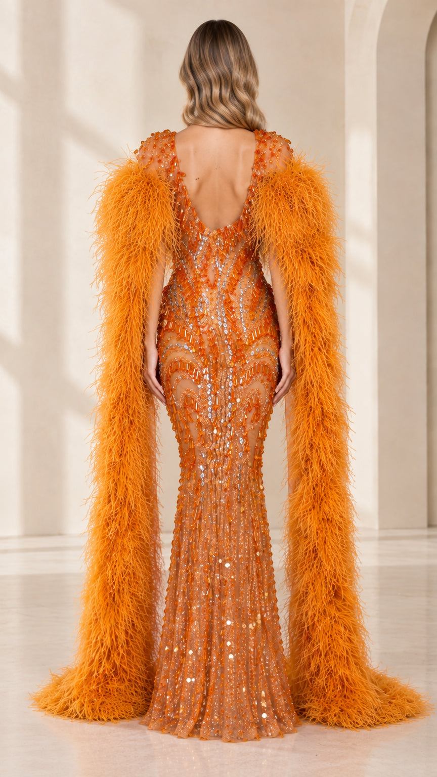 Back view of model in orange sequin formal dress featuring V-back and cascading feather cape
