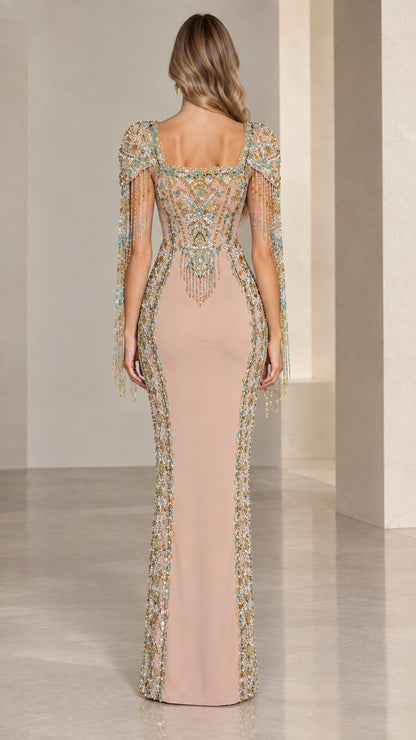 Back view of model in Nude embellished evening gown showcasing back beadwork and fringe details