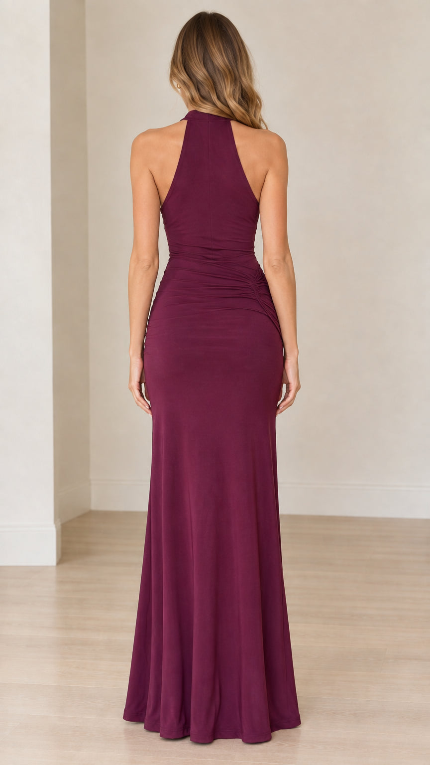 Back view of model wearing burgundy halter evening dress