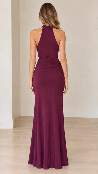 Back view of model wearing burgundy halter evening dress