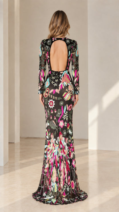 Back view of black sequin evening gown highlighting open back cutout detail