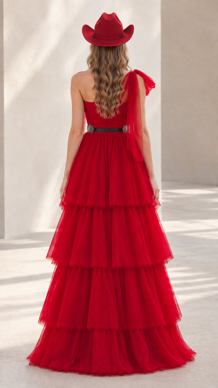 Back view of model in red one-shoulder tiered tulle gown showing back drape