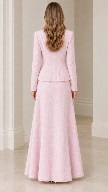 Back view of model in elegant blush pink tweed peplum jacket and maxi skirt set
