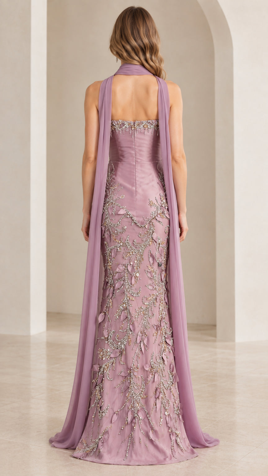 Rear view showing trailing chiffon scarf cape and fitted mermaid silhouette in mauve