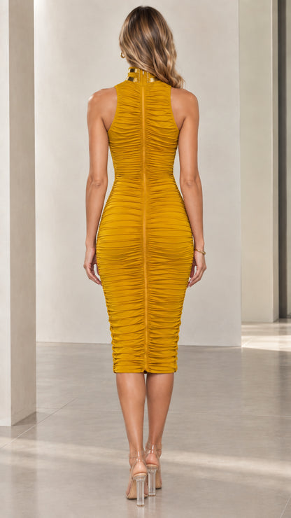 Back full-length view of woman wearing mustard yellow ruched midi dress