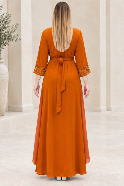 Back view of rust orange kaftan maxi dress with tied waist sash