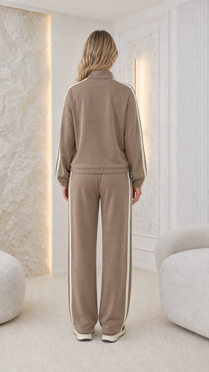 Back view of model wearing taupe zip-up loungewear set with straight-leg pants