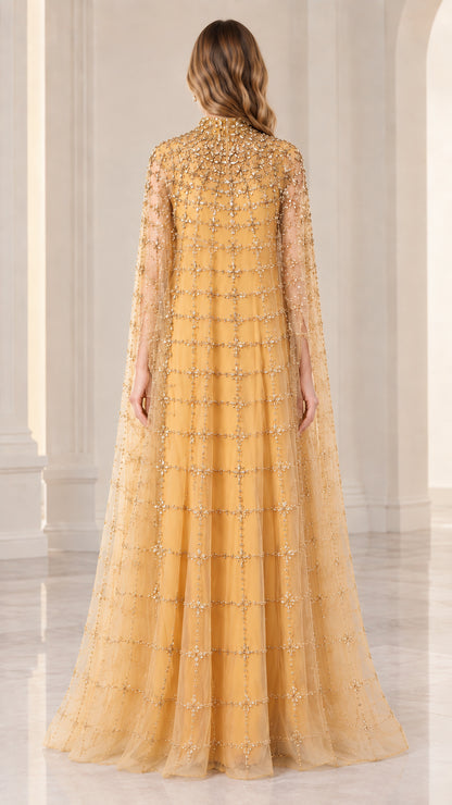 Back full view of woman wearing gold beaded cape formal dress
