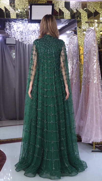 Back view of emerald green high neck beaded cape evening dress