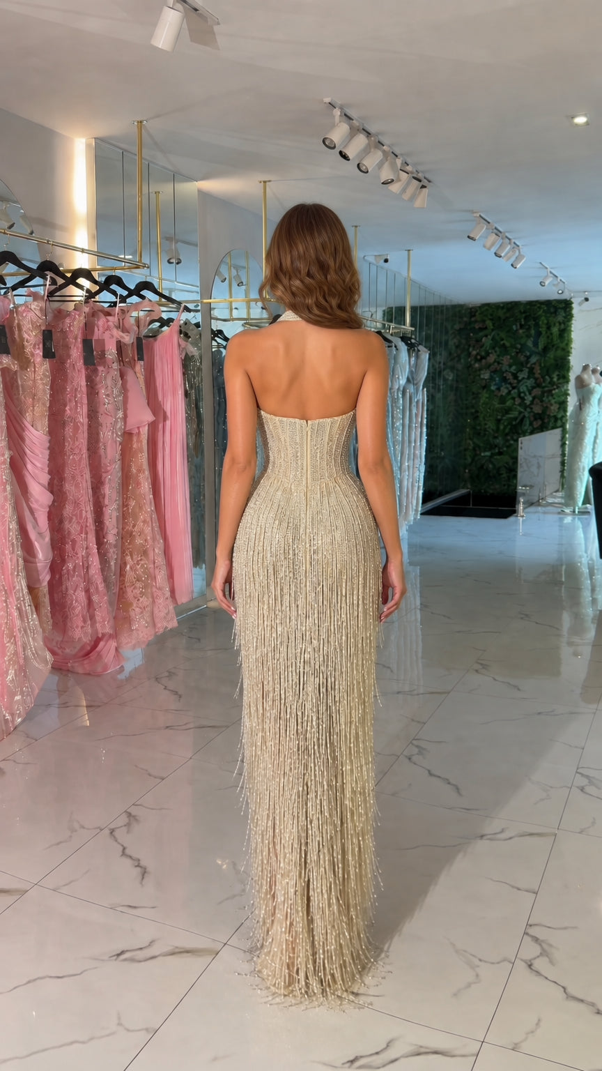 Backless view of champagne gold halter evening dress showing beaded fringe detail
