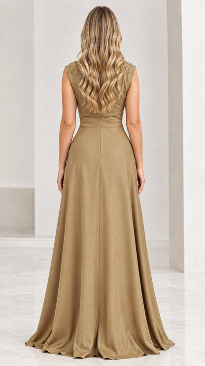 Back view of gold evening gown showing clean V-back and fluid pleated skirt