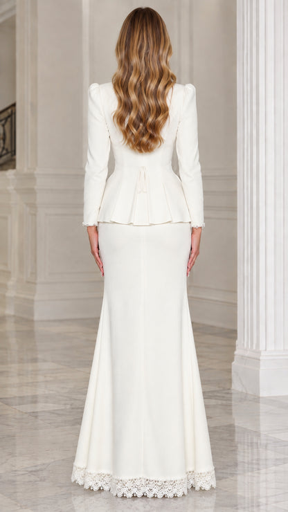 Back view of woman wearing white peplum jacket and trumpet maxi skirt