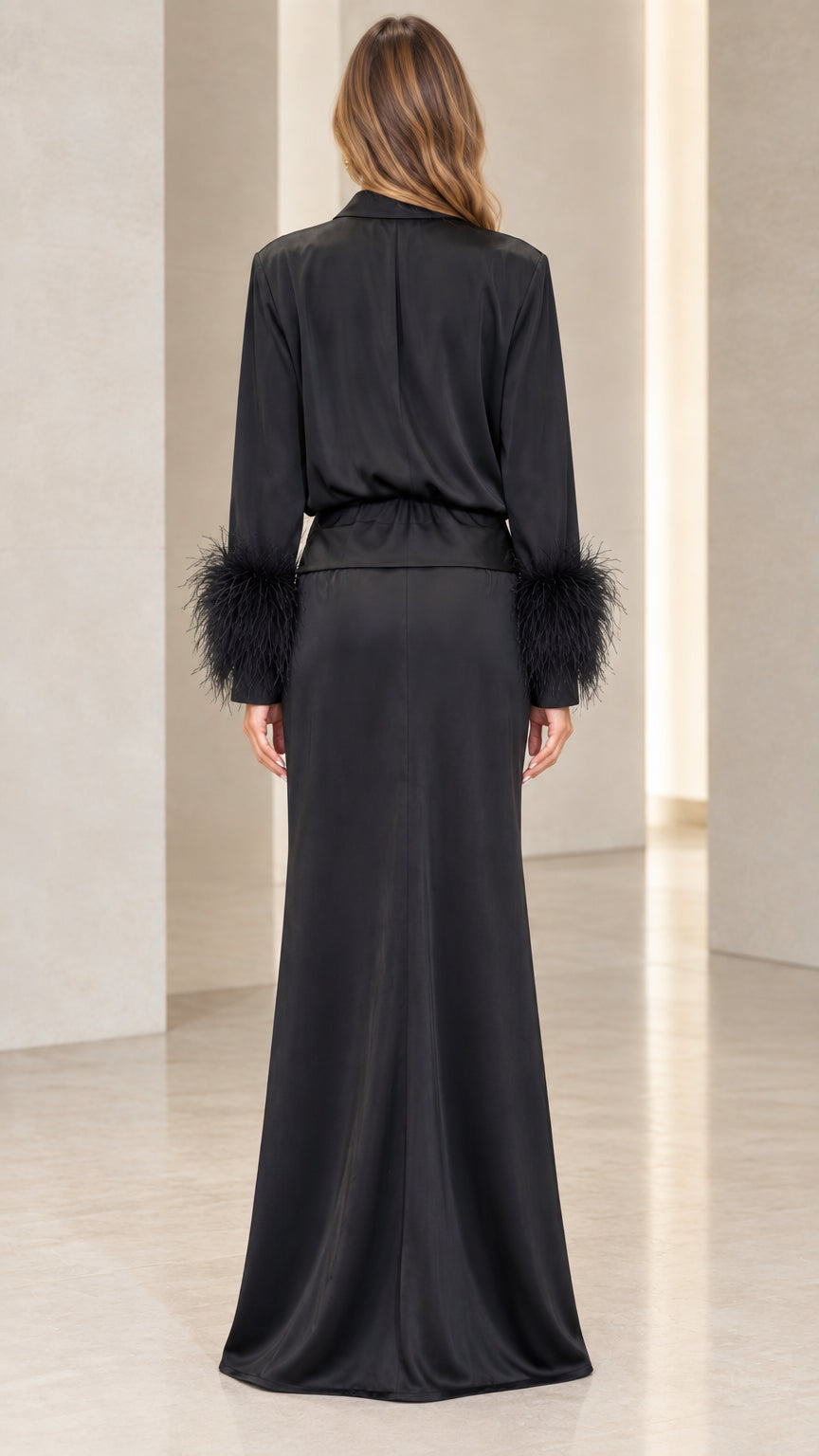 Back view of woman wearing long black satin dress with feather trimmed sleeves