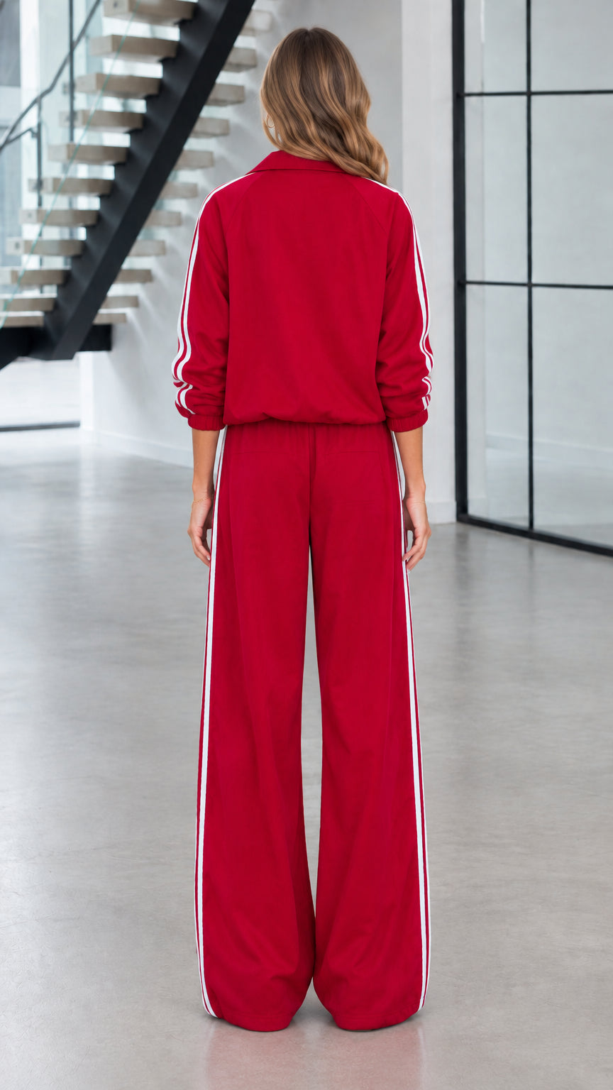 Back view of woman wearing red casual athletic two-piece tracksuit set