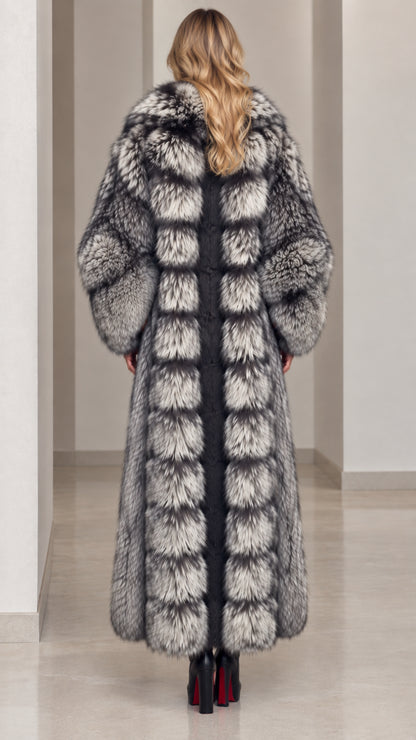 Back view of model in paneled silver grey full-length faux fur coat