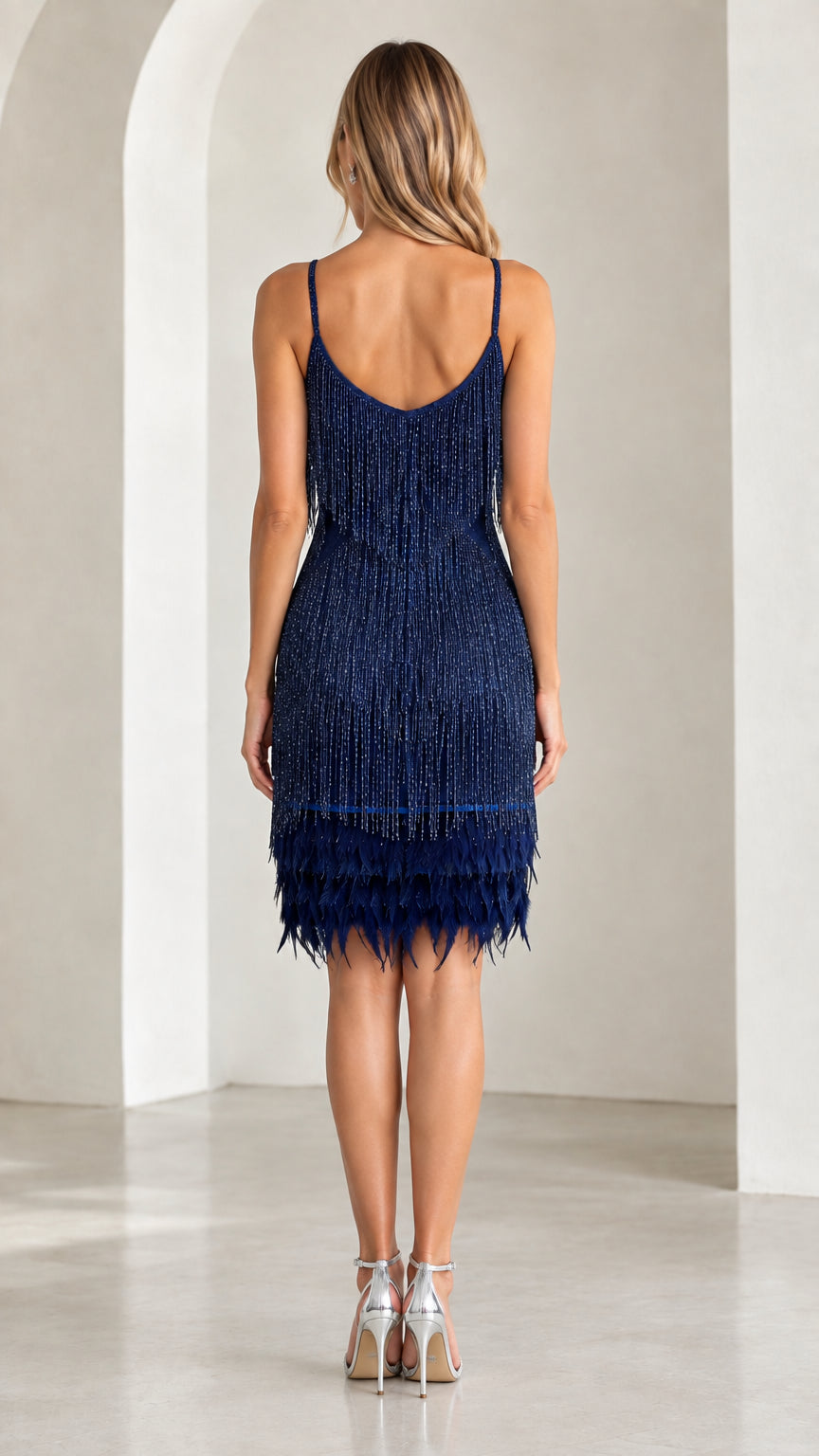 Back view of navy blue spaghetti strap fringe cocktail dress