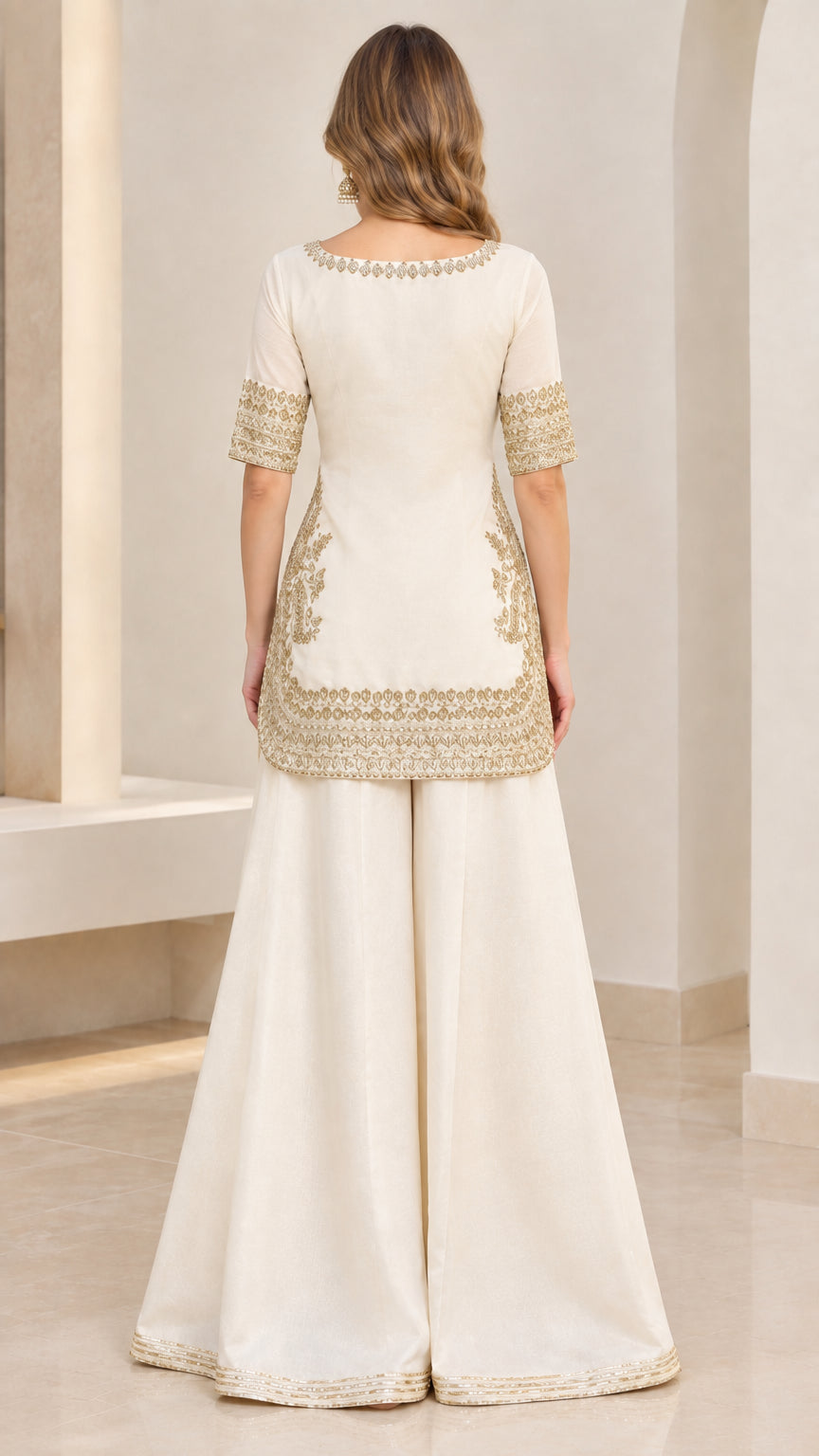 Back view of ivory embroidered kurti showing detailed hem and pants