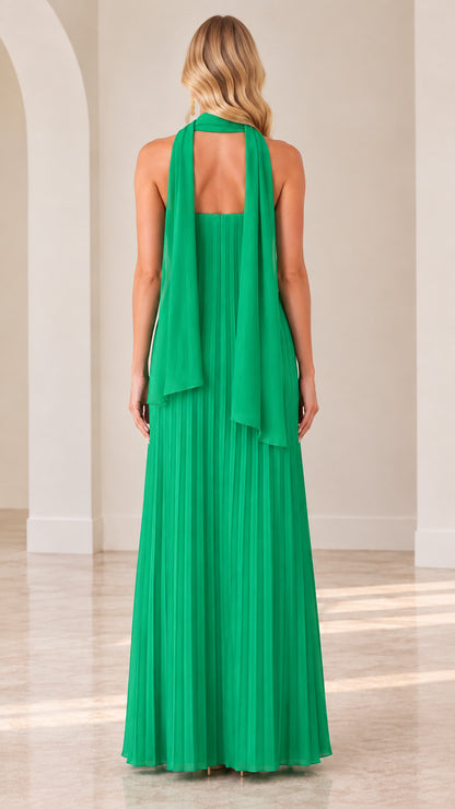 Back view of model in Emerald Green pleated evening dress showing flowing scarf drape