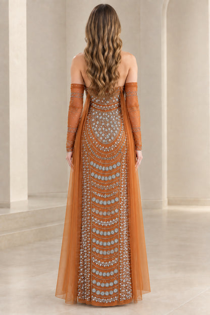 Back view of rust orange beaded formal evening gown with long sheer cape details