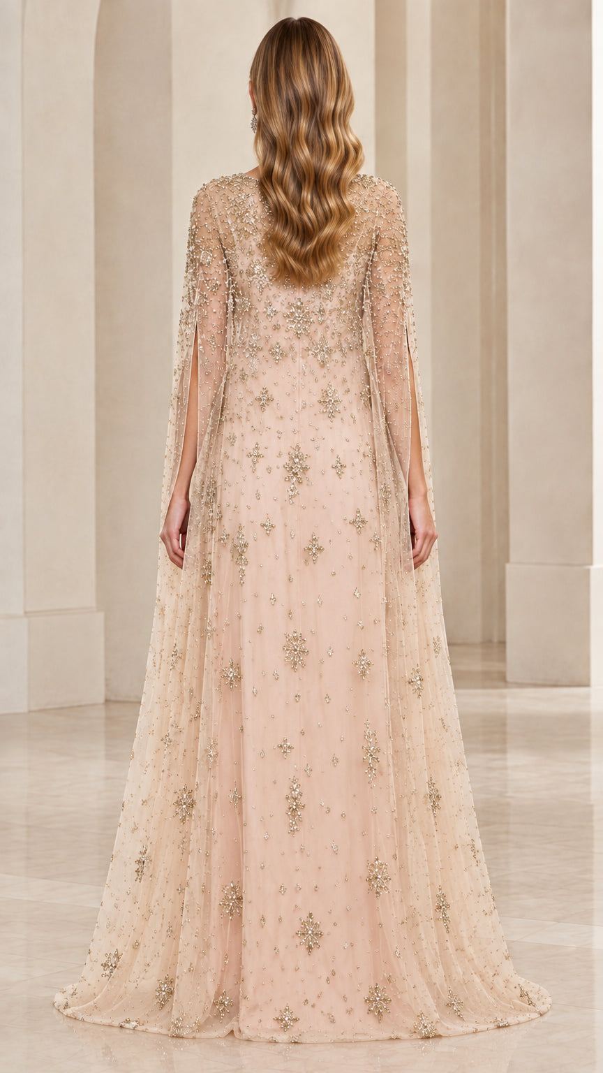 Back view of floor-length champagne embellished cape evening gown