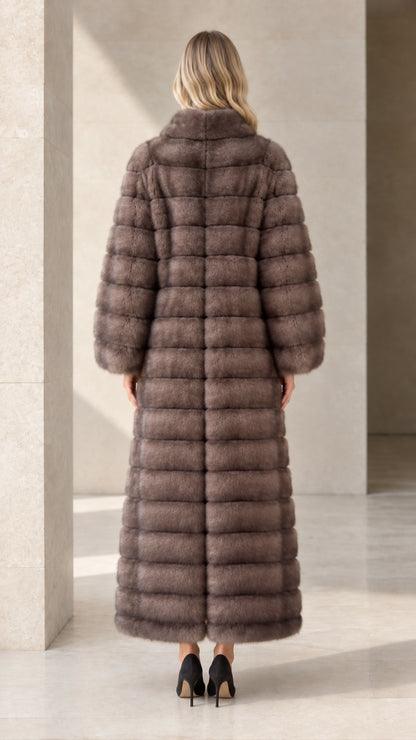 Back view of model showcasing the longline cut of the taupe faux fur maxi coat
