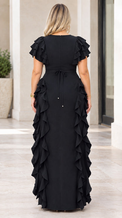 Back view of model wearing black maxi dress showing back tie and zipper