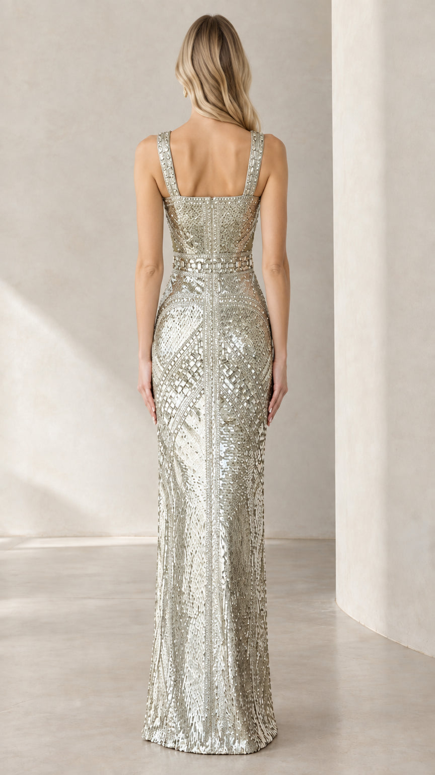 Back view of woman wearing silver sequin maxi gown showing square back neckline
