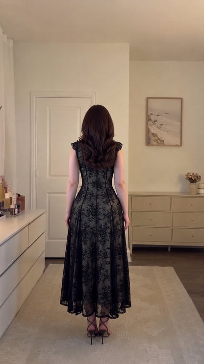 Back view of model wearing black floral lace corset midi dress with zipper detail