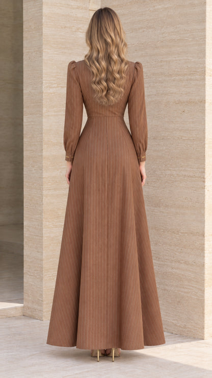Back view of brown A-line pinstripe maxi dress showing fitted waist
