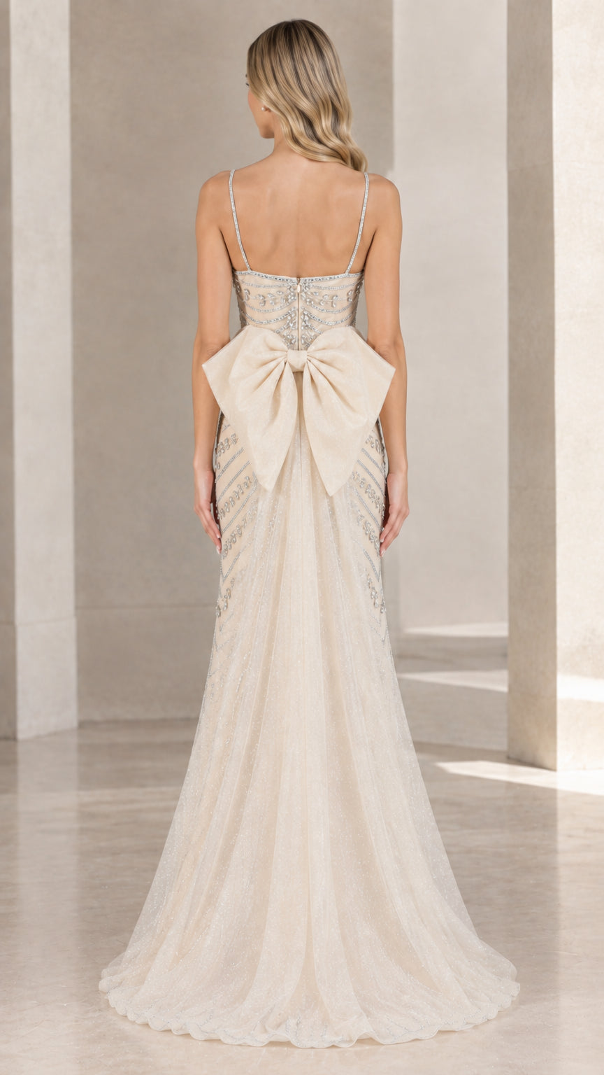 Back view of champagne formal gown featuring large statement bow detail