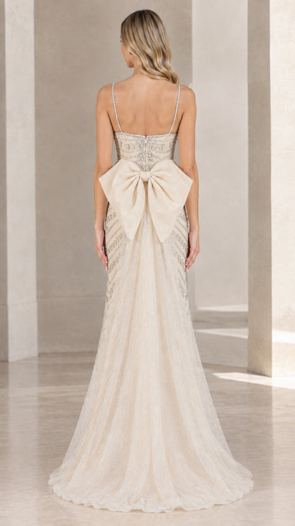 Back view of champagne formal gown featuring large statement bow detail