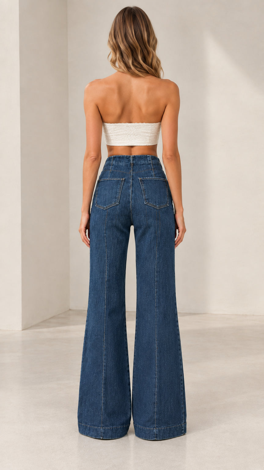 Back view of model wearing Classic Blue flare jeans with rear pockets