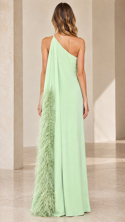 Back view of mint green one-shoulder formal dress showcasing feather-trimmed cape