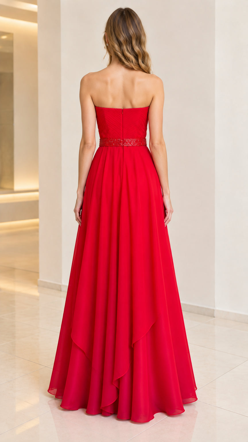 Back view of woman wearing strapless red evening dress with flowing skirt