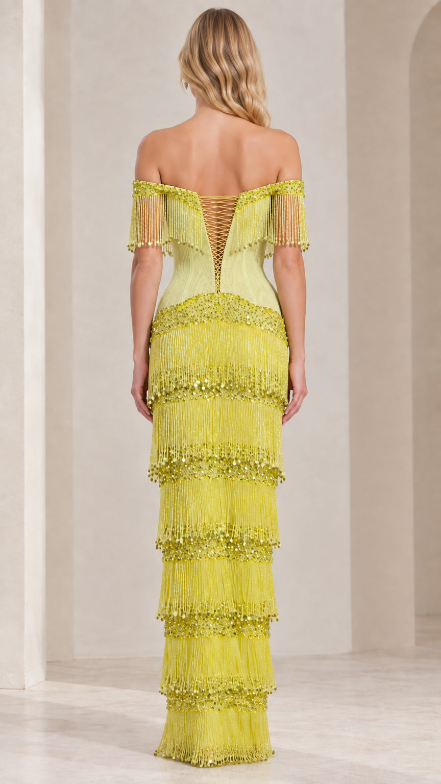 Back view of lime green fringe maxi gown showing corset lace-up closure