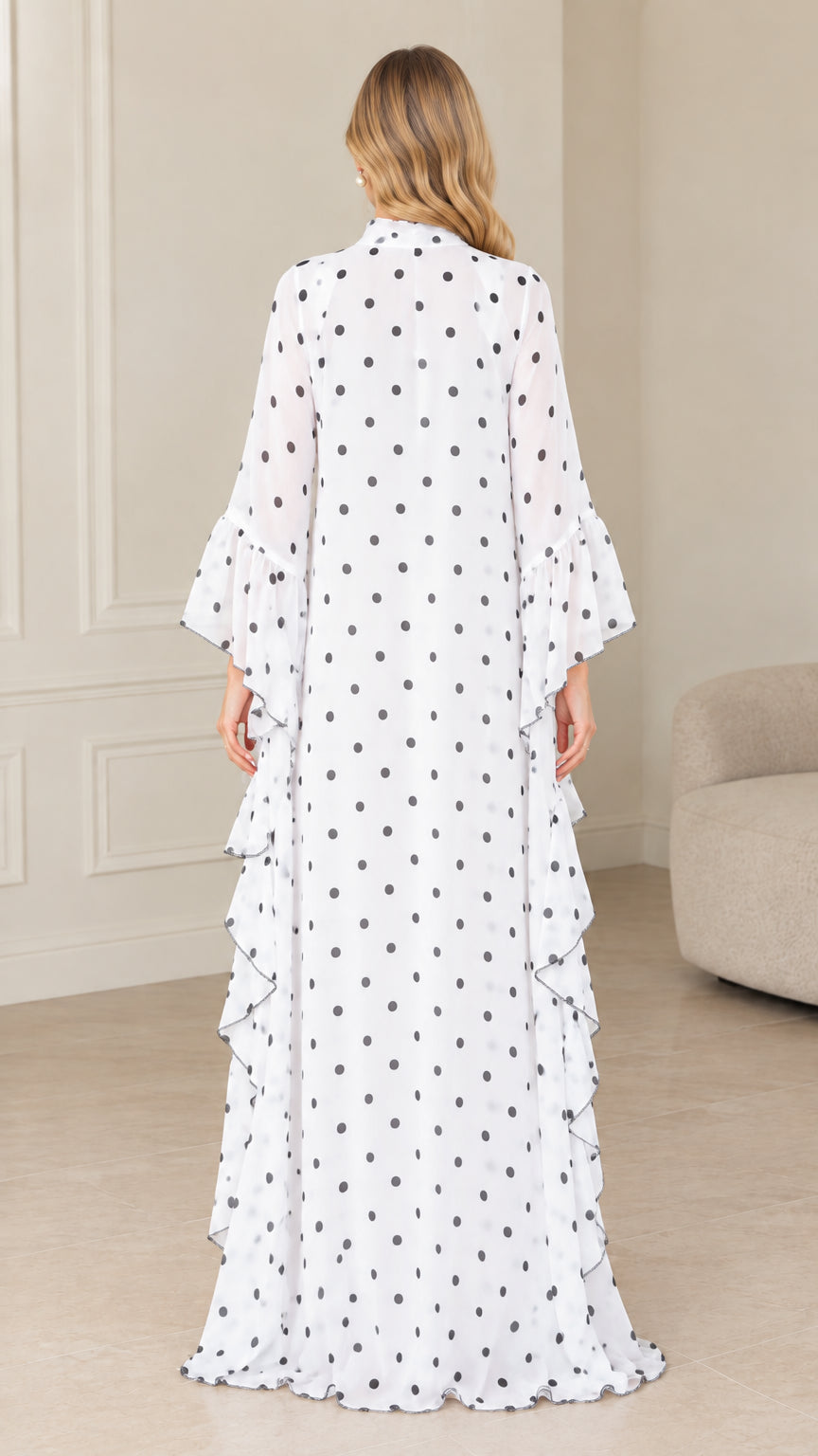 Back view of full-length white and black polka dot kaftan dress
