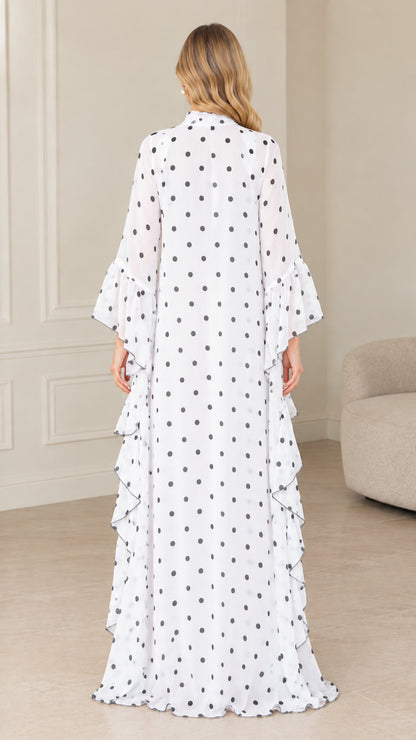 Back view of full-length white and black polka dot kaftan dress