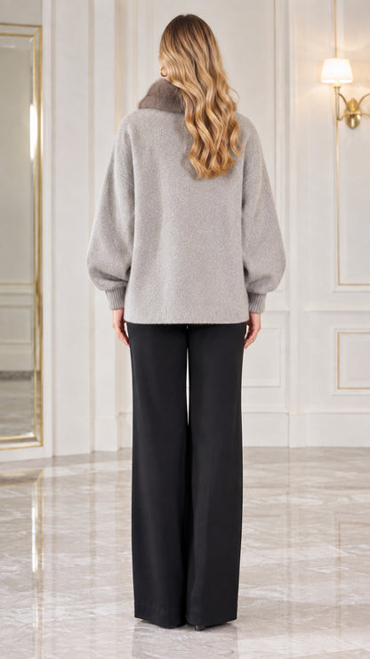 Back view of woman wearing heather grey knit cardigan jacket