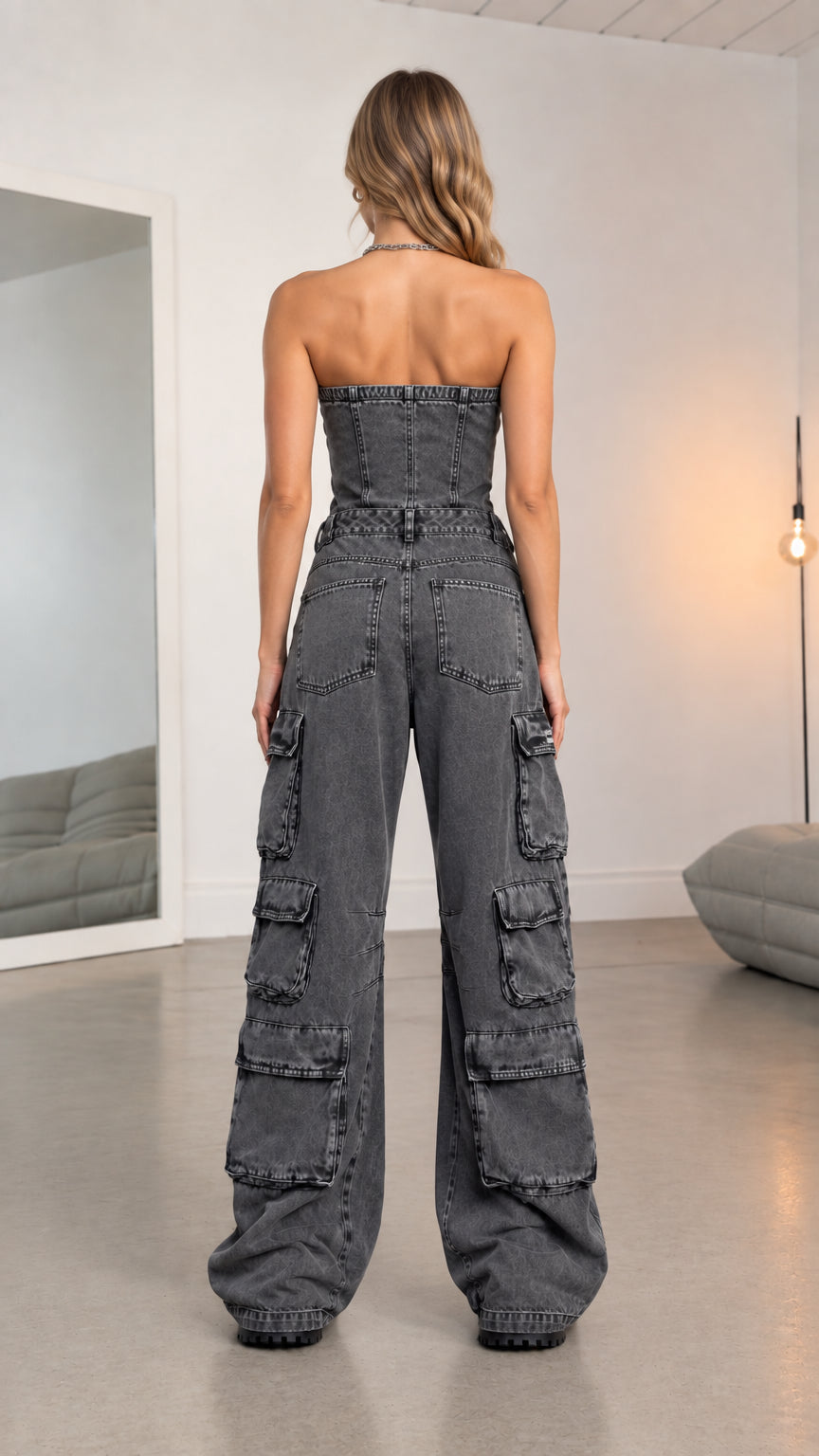 Back view of model wearing washed charcoal strapless wide leg denim jumpsuit