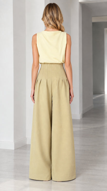 Back view of model showing clean sleeveless cut and flowing wide-leg trousers