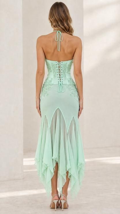 Back view of mint green dress highlighting halter tie and lace-up corset back
