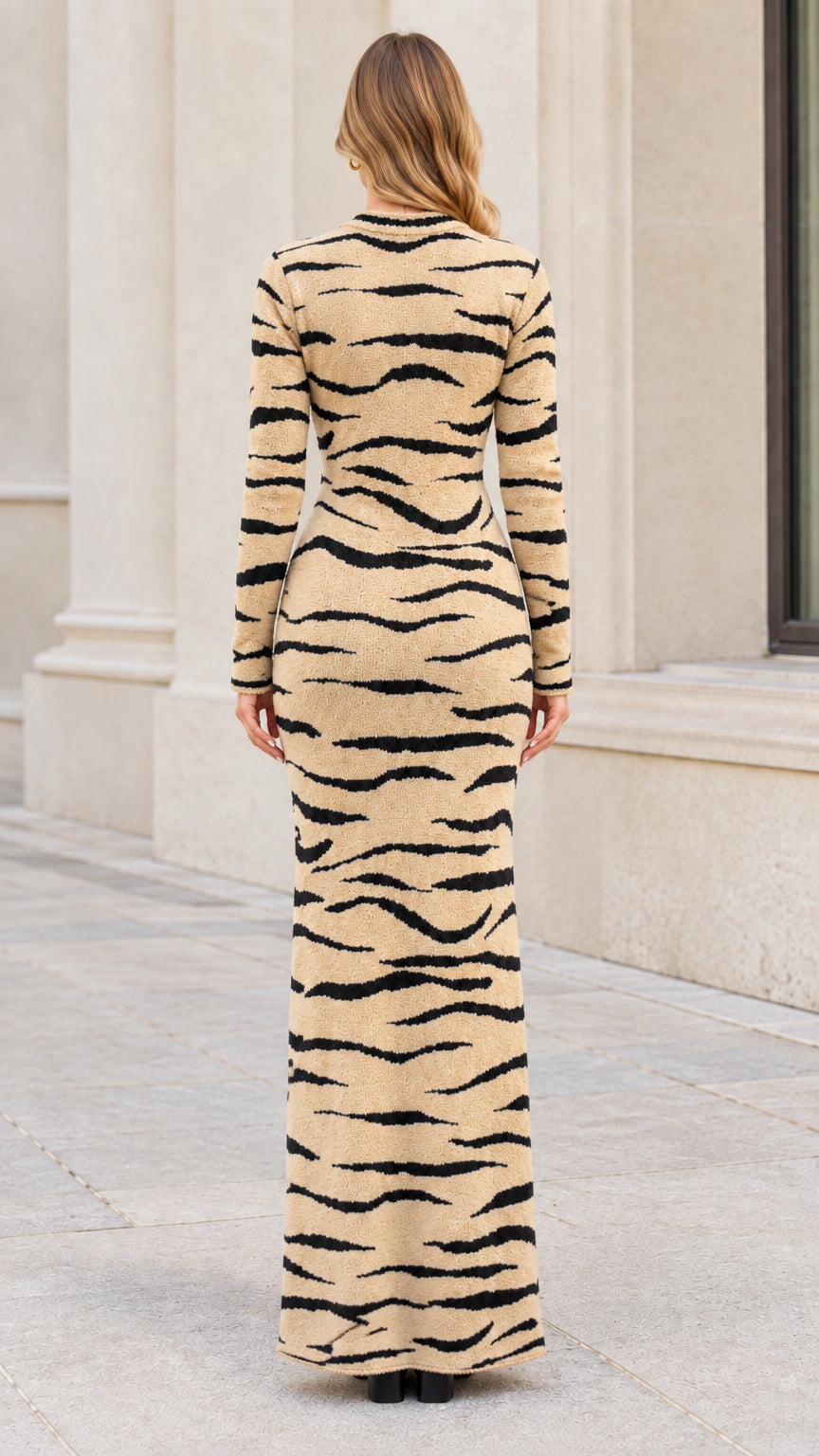 Back view of model in full length beige tiger stripe sweater dress