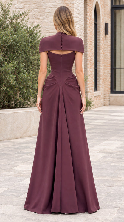 Back view of burgundy evening gown showing keyhole cutout and covered buttons