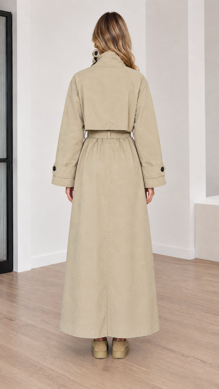Back view of women's beige trench coat highlighting back storm flap