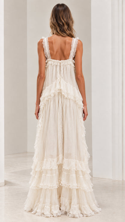Back view of ivory ruffled strap maxi dress showcasing low back design