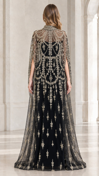 Back view of floor-length black evening dress with sheer embroidered cape