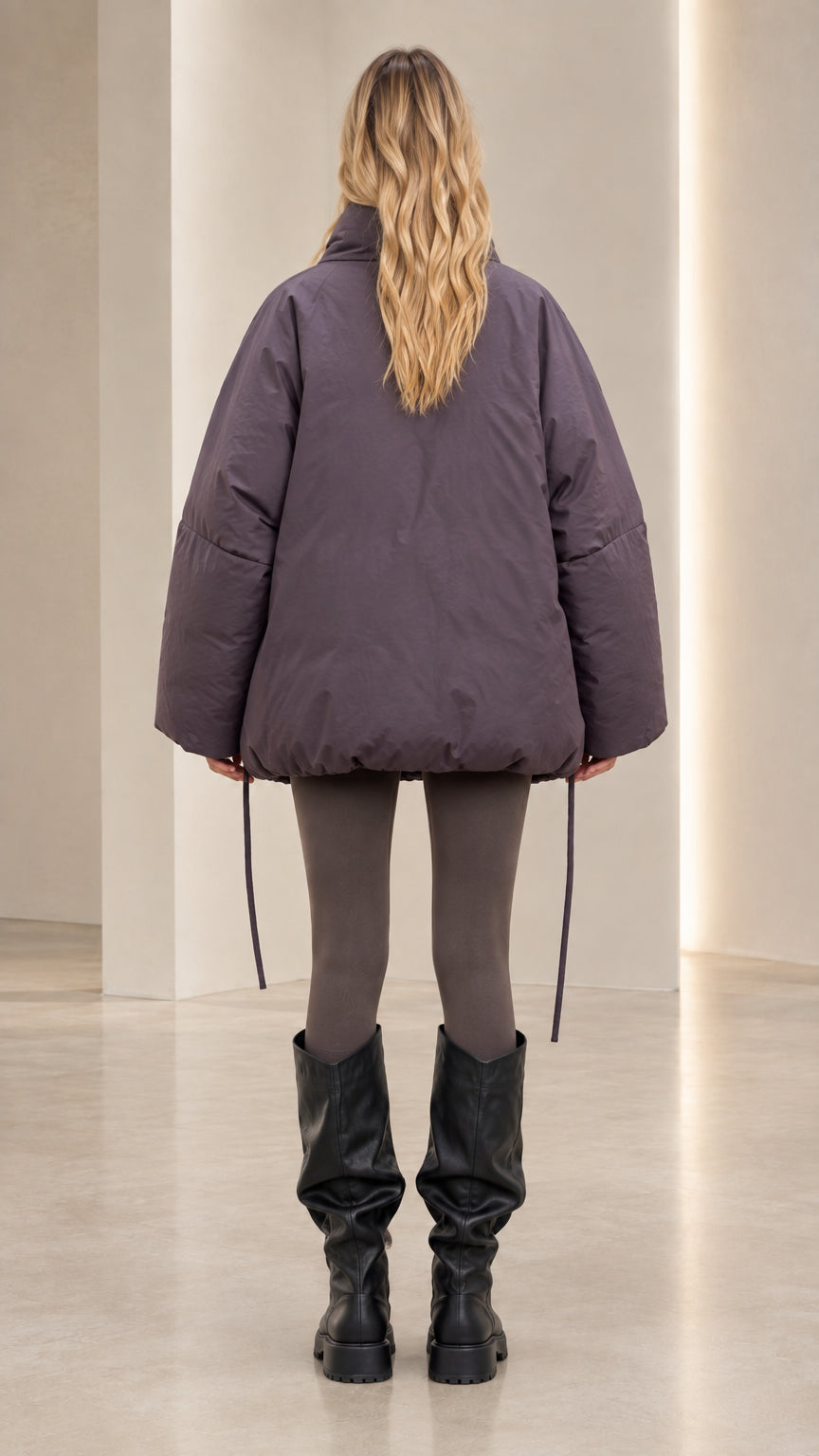 Back view of model wearing slate purple oversized winter puffer jacket